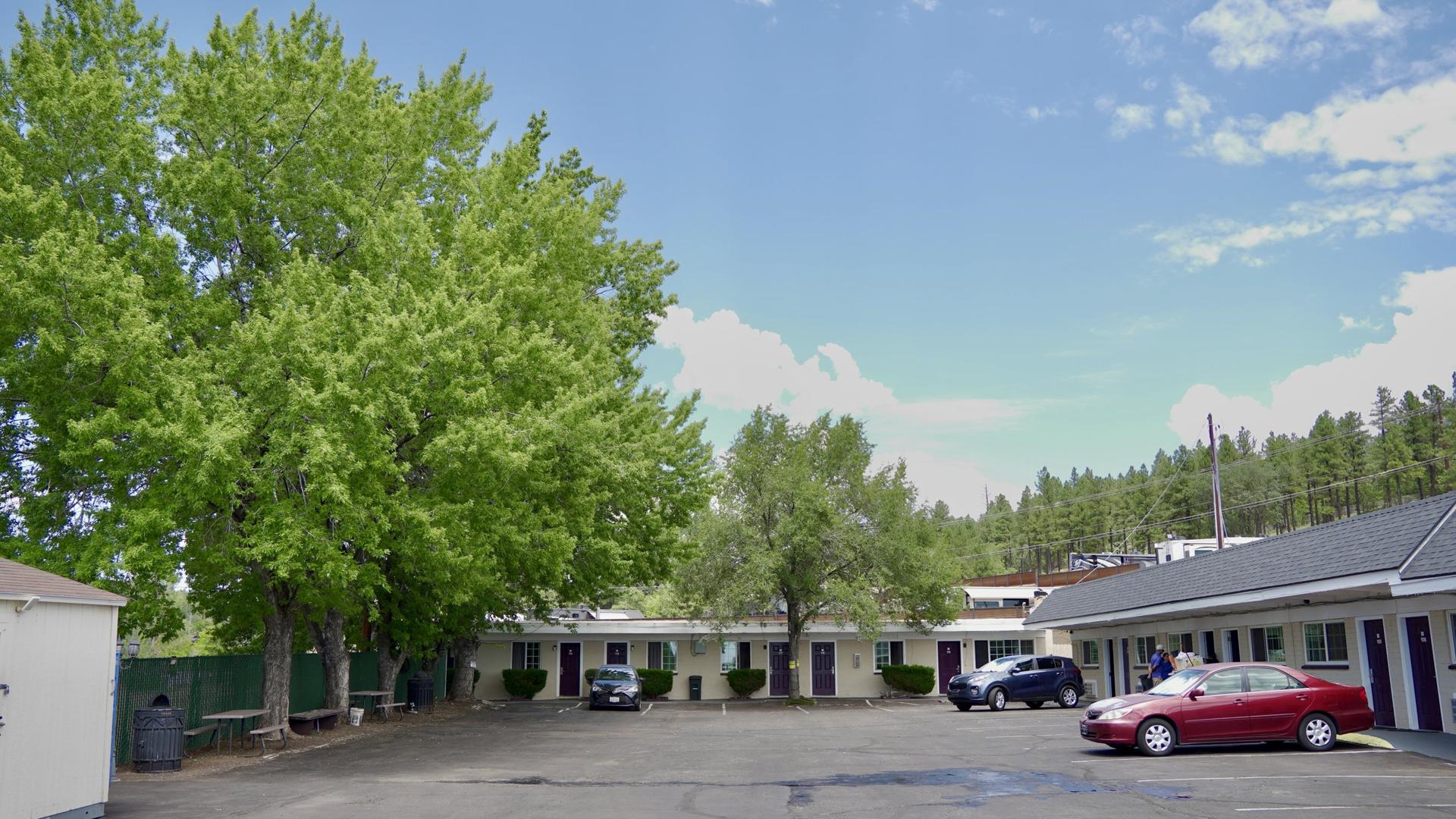 Motel grounds with mature shade trees and parking