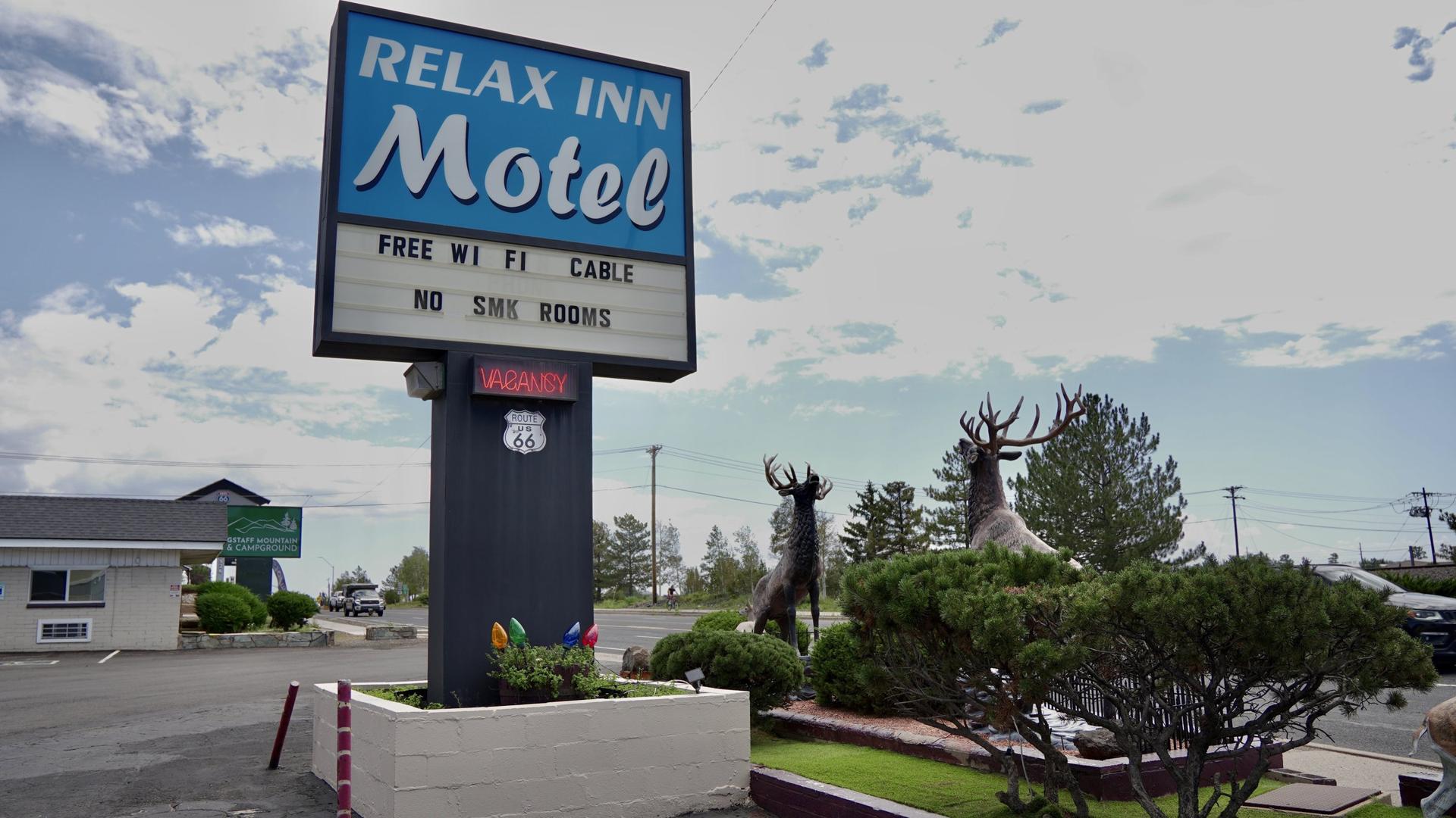 Relax Inn Motel sign against the Flagstaff sky