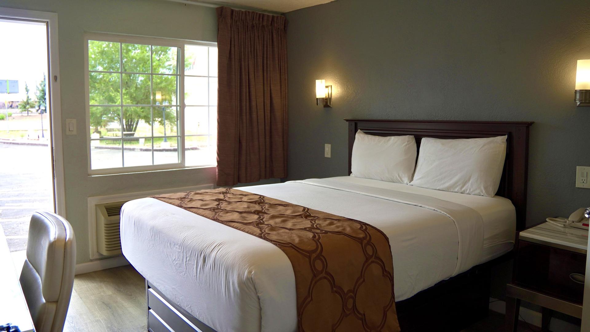 Queen bed by the window